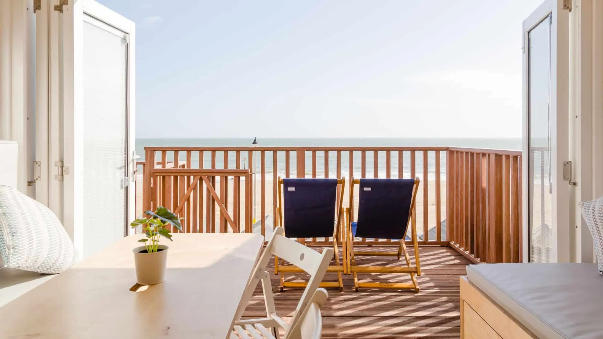 Late Autumn sunshine with lunch table and deckchairs