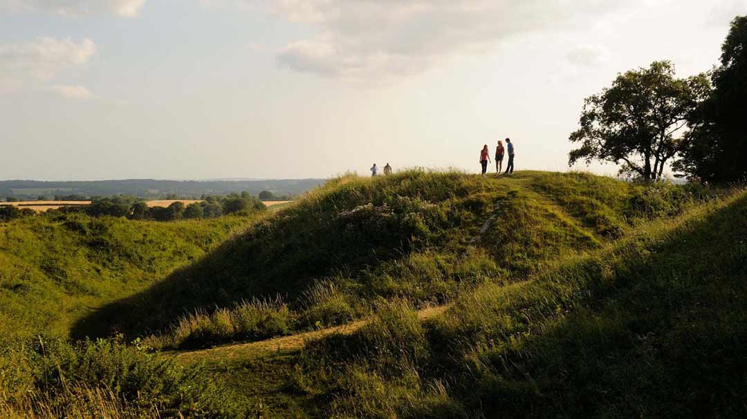 Visitors enjoying the views of badbury rings in Dorset